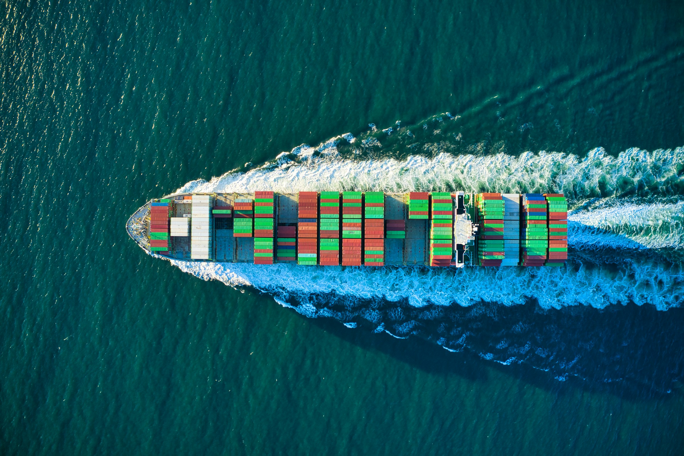 Container ship at port being loaded by gantry cranes